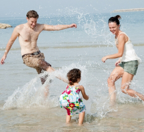 Family playing in the waves at the beach